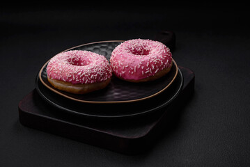 Delicious fresh sweet donuts in pink glaze with strawberry filling