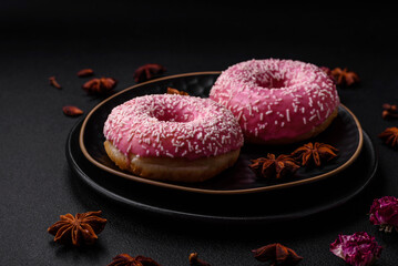 Delicious fresh sweet donuts in pink glaze with strawberry filling