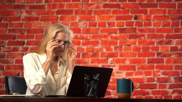 Frustrated upset mature pretty woman cant see computer screen. Put glasses on, adjust, angry at bad eyesight vision, planning budget, review savings and expenses feels tax stress, bills. Copy space