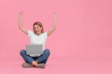 Emotional woman with laptop on pink background. Space for text