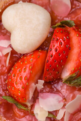 Delicious fresh sweet tartlets with strawberries and coconut flakes