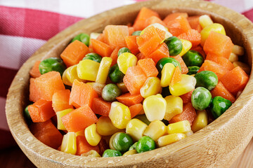 Close up of a wooden bowl of delicious mixed vegetables