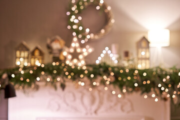 Abstract blur. Christmas tree. Close-up a small house, Cones, garland, and other Christmas tree toys. light from the garlands