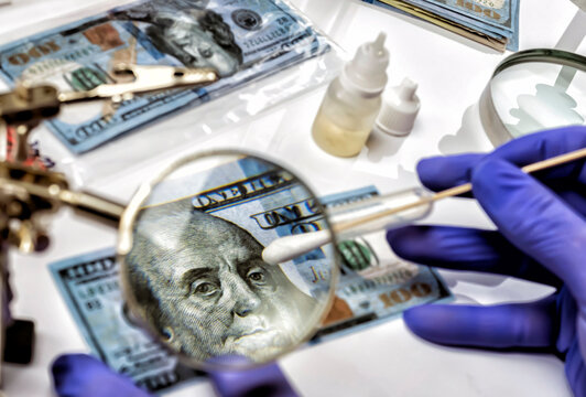 Police scientist investigates fake dollar bills and passports in criminal investigation unit, conceptual image