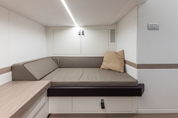 Interior of a modern yacht, living room with sofa and bed