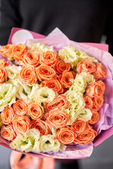 Beautiful bouquet of mixed flowers in woman hand. Floral shop concept . Beautiful fresh cut bouquet. Flowers delivery