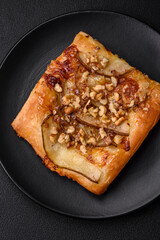 Delicious fresh sweet pie or pizza with pear, brie cheese, honey and nuts