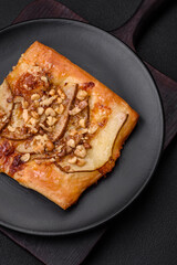 Delicious fresh sweet pie or pizza with pear, brie cheese, honey and nuts