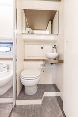 Naklejka na ściany i meble yacht Interior of a modern bathroom with white bathtub and toilet. Nobody inside