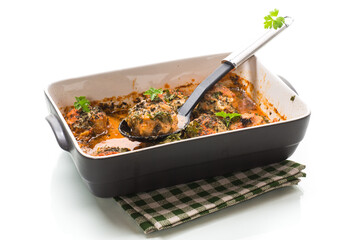 cooked meatballs from minced meat in a sauce in a ceramic form
