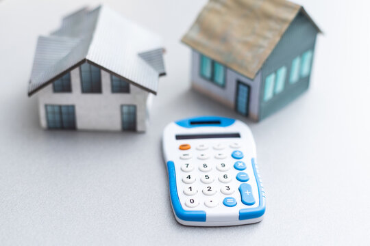 House is placed on the calculator. Imagine calculating to buy a home. planning savings money to buy a home concept for property, mortgage and real estate investment. to buy a house.