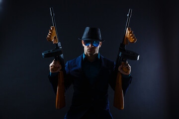 Mature man in sunglasses with gun