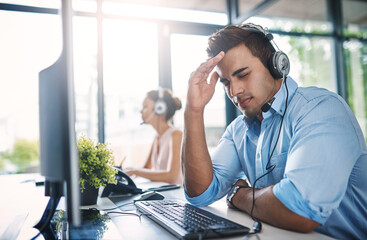 Businessman, call center and headache in burnout, stress or overworked strain at the office. Tired...