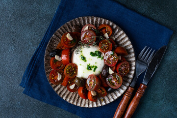 Italian caprese salad with sliced tomatoes, mozzarella, basil, olive oil. Top view. Healthy food. Italian salad
