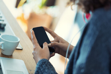 Woman possibly telecommuting, tech amidst coffee essentials