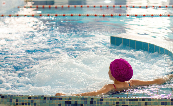The girl swims in a special wellness pool. Jacuzzi. Classes with children in the pool.