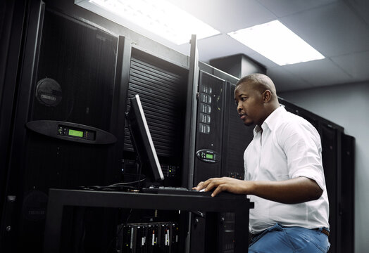 IT support, black man or coding on laptop in server room for big data, network glitch or digital website. Code, fixing or technician typing on computer testing UX, programming or software development