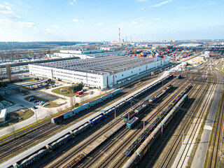 Cargo trains close-up. Aerial view of colorful freight trains on the railway station. Wagons with goods on railroad. Heavy industry. Industrial conceptual scene with trains. Top view from flying drone