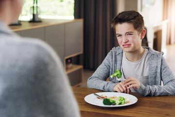Disgust, vegetable and fear with child and broccoli for nutrition, health and cooking. Sad, angry...