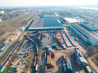 Cargo trains close-up. Aerial view of colorful freight trains on the railway station. Wagons with...