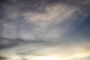 Numerous fluffy clouds in the sky at sunset.