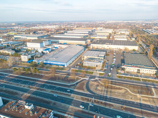 Aerial view of goods warehouse. Logistics center in industrial city zone from above. Aerial view of trucks loading at logistic center. View from drone.