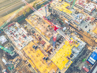 Busy Construction Site and Construction Equipment. new residential area. crane and building under construction . aerial view