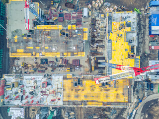 Busy Construction Site and Construction Equipment. new residential area. crane and building under...