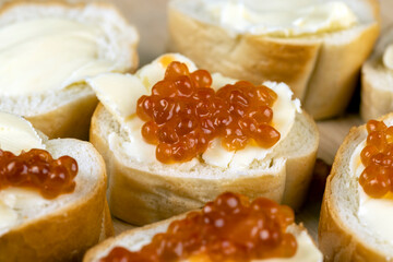 Thinly sliced baguette with salmon caviar and butter