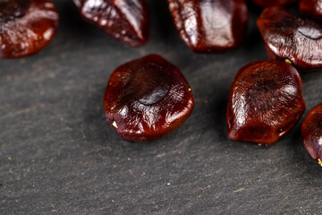 brown tamarind seeds on the table, scattered seeds