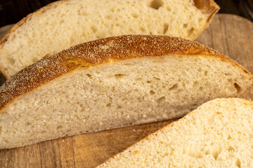 A cut loaf of round-shaped wheat bread