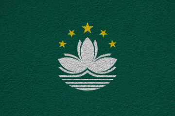 Macau flag on a textured background. Concept collage.