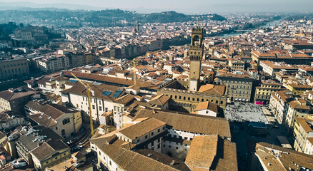 Fototapeta na wymiar Aerial view of famous tower and Palazzo Vecchio square and Florence cityscape, Italy. High quality photo