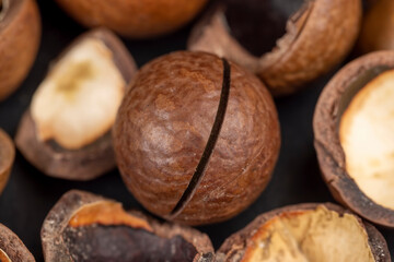 A bunch of ripe macadamia nuts in a hard shell