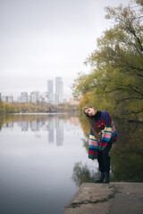 Girl in sweater on pier in autumn