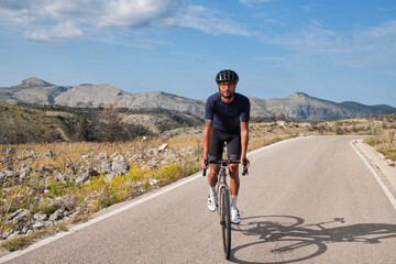 Pass Vall De Ebo.
Cyclist training on road bike in mountain.
Sport motivation.
Cycling holiday in Spain.