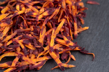 Sliced into thin slices of red-orange carrots in the kitchen