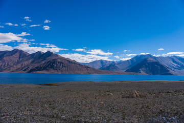 Mountains and Pangong tso (Lake). It is huge lake in Ladakh, altitude 4,350 m (14,270 ft). It is 134 km (83 mi) long and extends from India to Tibet. Leh, Ladakh, Jammu and Kashmir, India