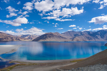 
Mountains and Pangong tso (Lake). It is huge lake in Ladakh, altitude 4,350 m (14,270 ft). It is 134 km (83 mi) long and extends from India to Tibet. Leh, Ladakh, Jammu and Kashmir, India