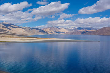 Mountains and Pangong tso (Lake). It is huge lake in Ladakh, altitude 4,350 m (14,270 ft). It is 134 km (83 mi) long and extends from India to Tibet. Leh, Ladakh, Jammu and Kashmir, India