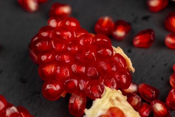 Peeled red pomegranate with ripe grains