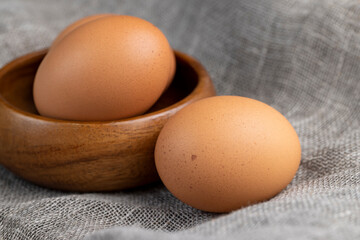 A whole orange chicken egg close-up on the table