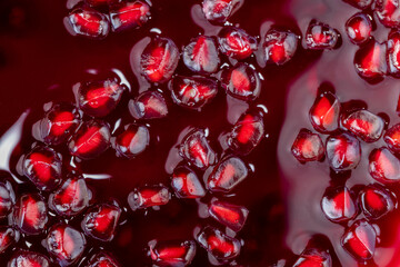 Grains of red ripe pomegranate close up