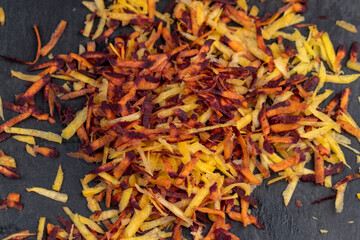 Finely grated red-orange carrots in the kitchen