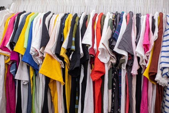 T-shirts Of Different Colors And Sizes For Sports And Summer Hang On Hangers In Clothing Store.. Small Business. 