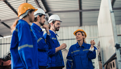 A group of robotic engineers collaboratively brainstorms and discusses ideas with cross-functional teams on a whiteboard to create strategies and solutions to make the working process more efficient.