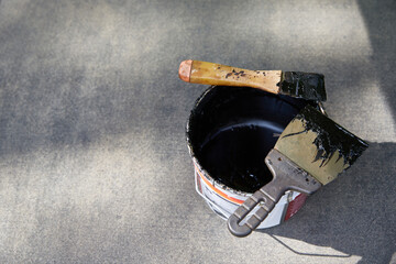 Mastic for the roof. Spatulas in waterproofing mastic. Copy space
