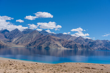 beautiful Panorama of mountain background blue lake and some green field in front of the lake in Pangong tso, Leh Ladakh, India