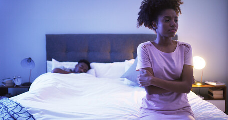 Black couple, bedroom and night with a woman sad while thinking of divorce, stress or depression. Man sleeping in home bed with partner upset about fight, marriage problem and cheating or infertility