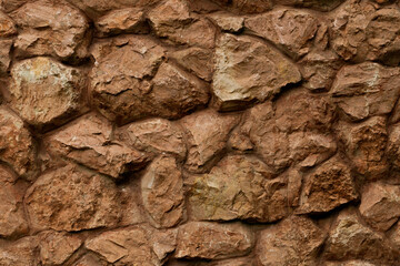 Old coarse panoramic stone wall of natural stones